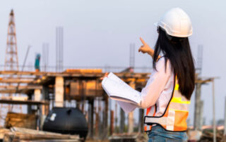 Female construction manager studies work site