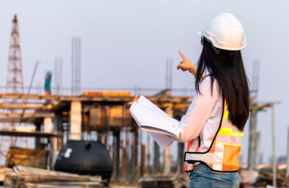 Female construction manager studies work site