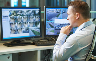 A loss prevention manager scans feeds from security cameras.