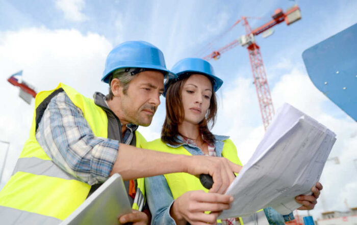 A female construction manager consults with an engineer at a construction site.