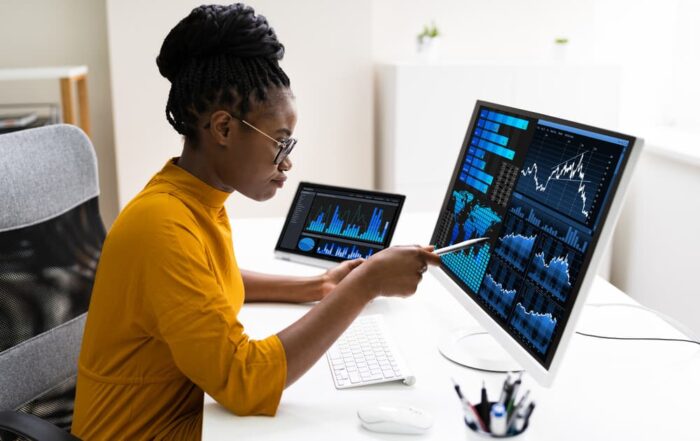 A financial analyst works at her desk reviewing accounting data