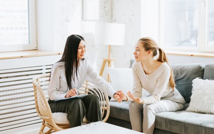 A mental health counselor consoles her female client